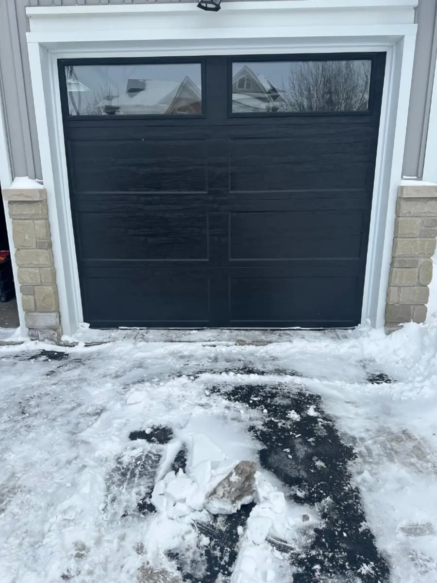 Certified technician repairing a residential overhead door